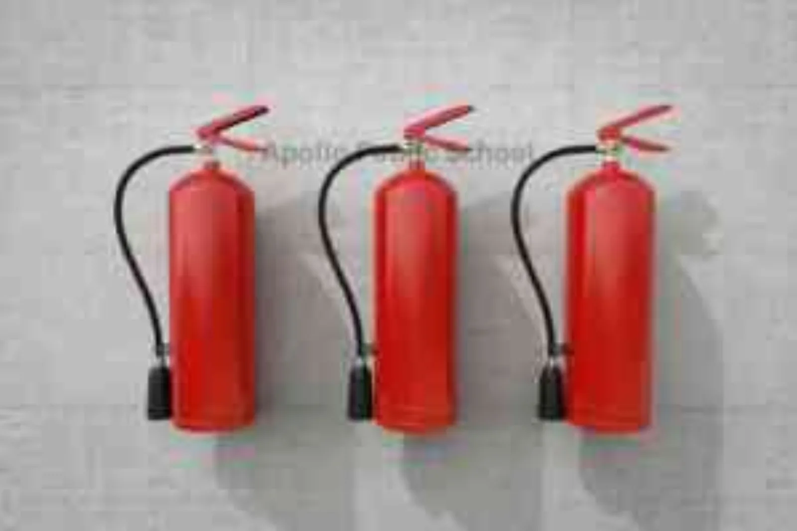 Three red fire extinguishers mounted on a wall