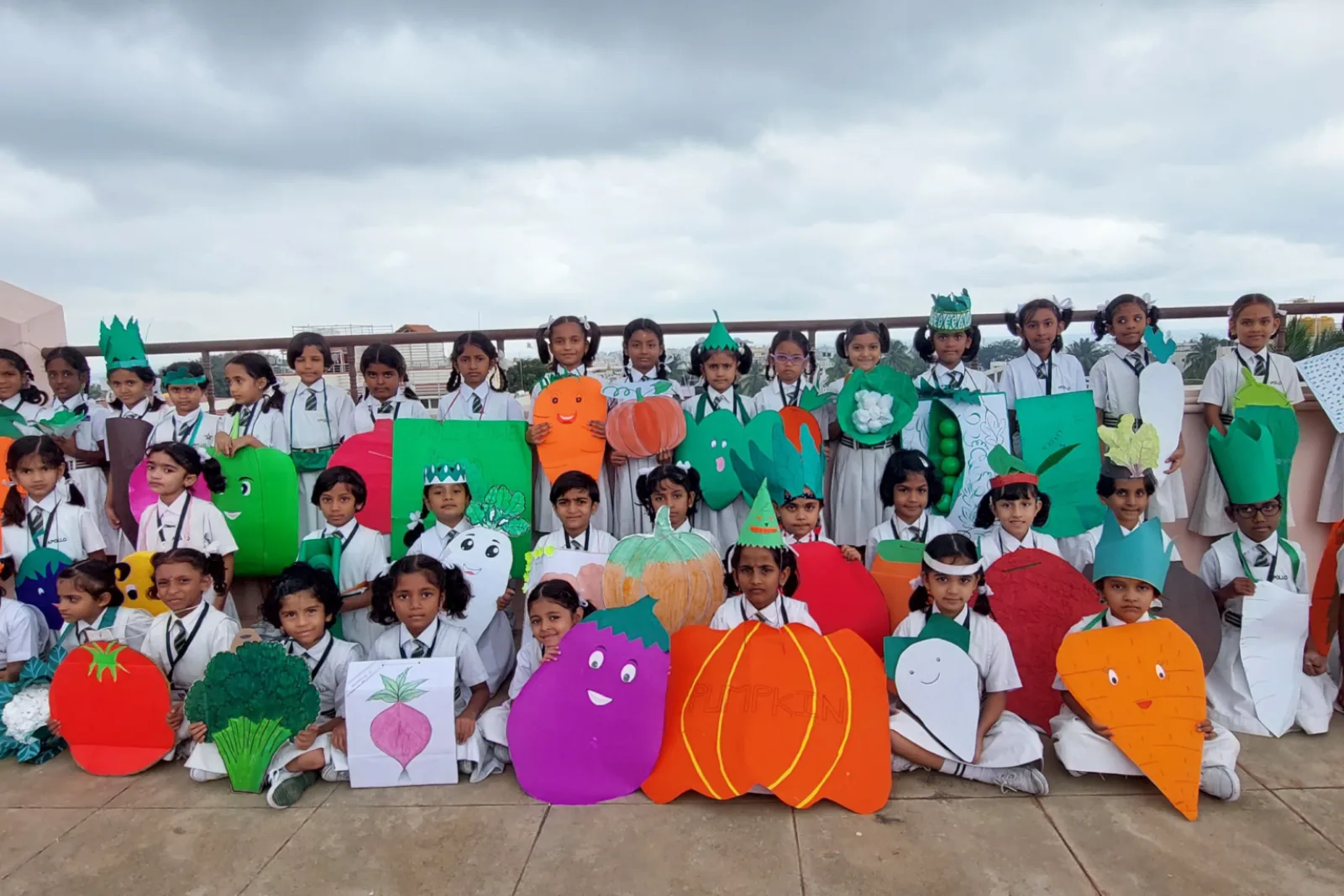 Students posing together outdoors as part of an environmental awareness activity